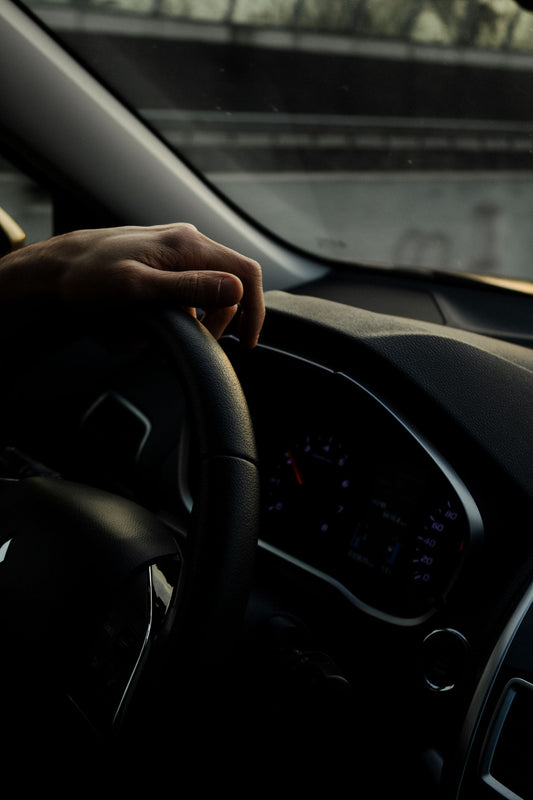 Hand on the steering wheel while driving