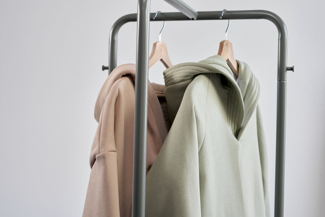 Hoodies hanging on a minimalist clothes rack