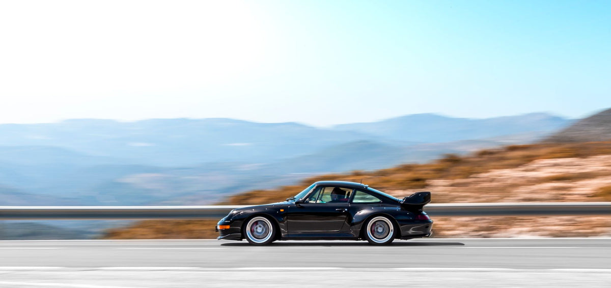 Sports car driving on a curvy mountain road